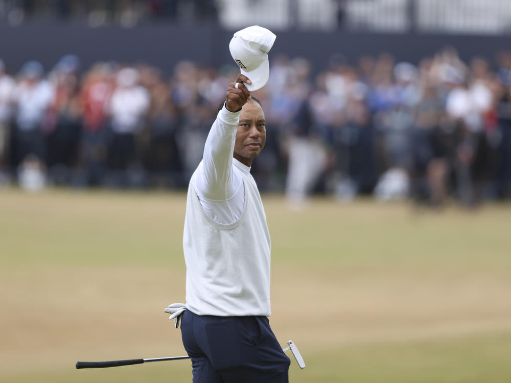 Tiger Woods gestures to the crowd at the end of his second round of the British Open at St. Andrews, Scotland, on Friday.