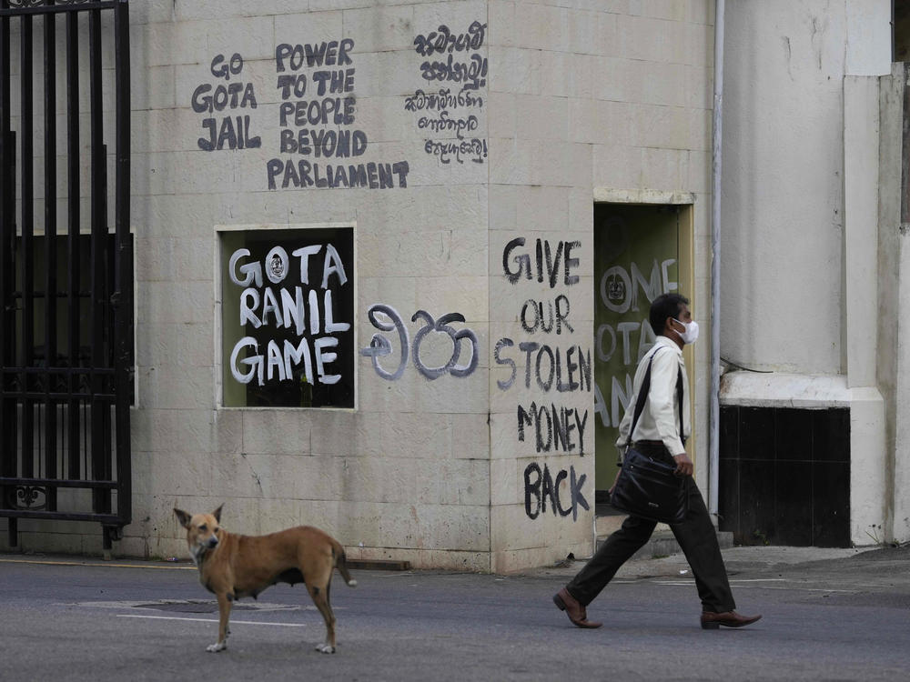 A man walks past a security point outside president's official residence in Colombo, Sri Lanka, on Friday.