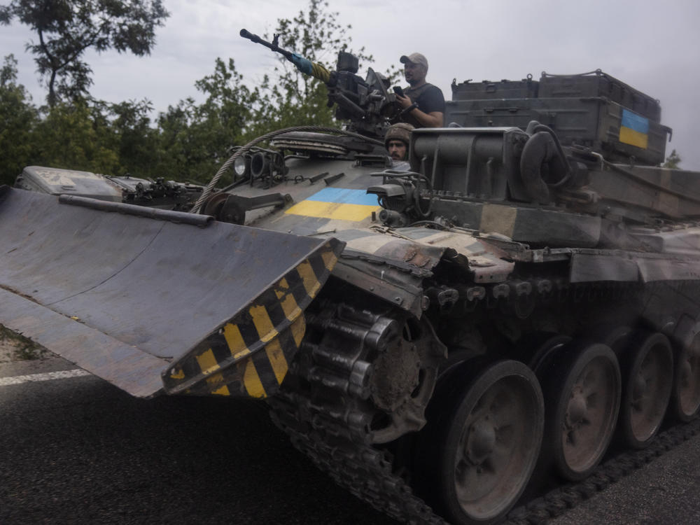 Ukrainian soldiers ride a tank on a road, in Stupochky, Donetsk region, eastern Ukraine, Sunday, July 10, 2022.