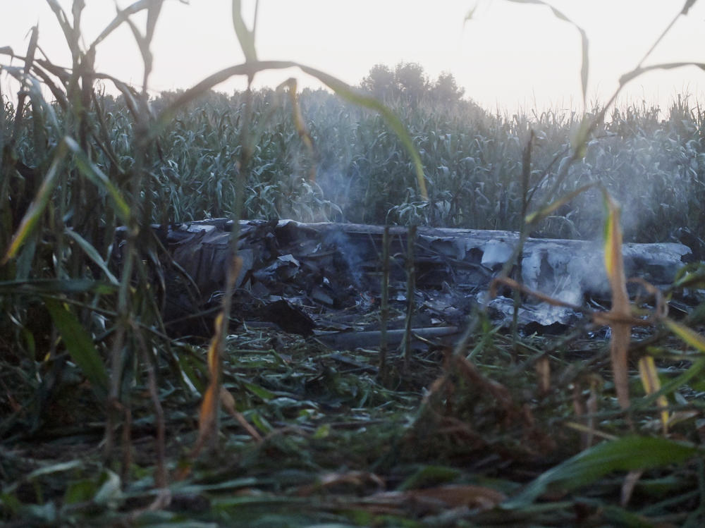 Debris of an Antonov cargo plane smolders in Palaiochori village in northern Greece, Sunday, July 17, 2022, after it reportedly crashed Saturday near the city of Kavala.
