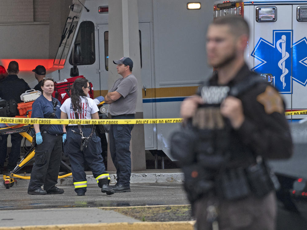 Emergency personnel gather after a deadly shooting Sunday, July 17, 2022, at the Greenwood Park Mall, in Greenwood, Ind.