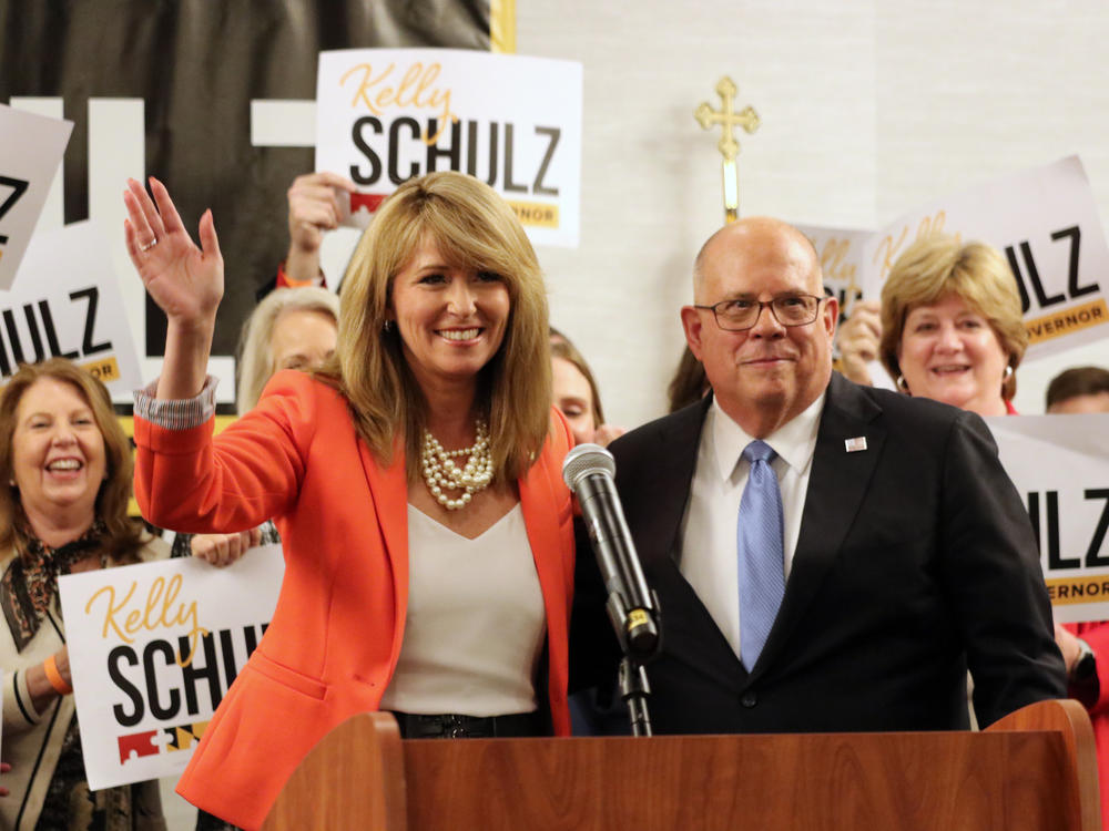 Kelly Schulz, who is seeking the Republican nomination for governor of Maryland, waves after receiving the endorsement of Gov. Larry Hogan, right, who is term limited, on March 22, 2022, in Annapolis, Md.