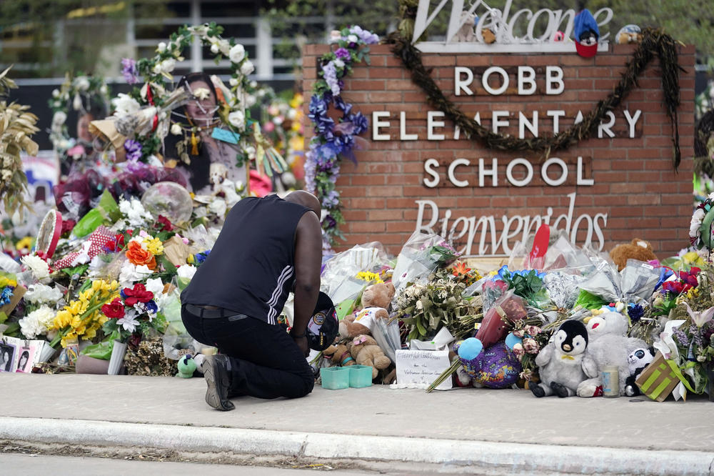 Reggie Daniels pays his respects a memorial at Robb Elementary School on June 9, 2022, in Uvalde, Texas. Nearly 400 law enforcement officials rushed to the mass shooting that left 21 people dead at the school, but it was more than an hour before the gunman was finally confronted and killed, according to a report from investigators released Sunday, July 17, 2022.