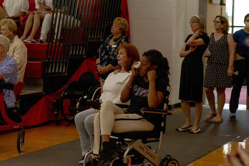 Robin Wooten wipes tears from her eyes during Dance Mobility's Adapted Ballroom Dance Competition. Before Wooten was diagnosed with Multiple Sclerosis, she danced ballroom and taught her son to dance. 