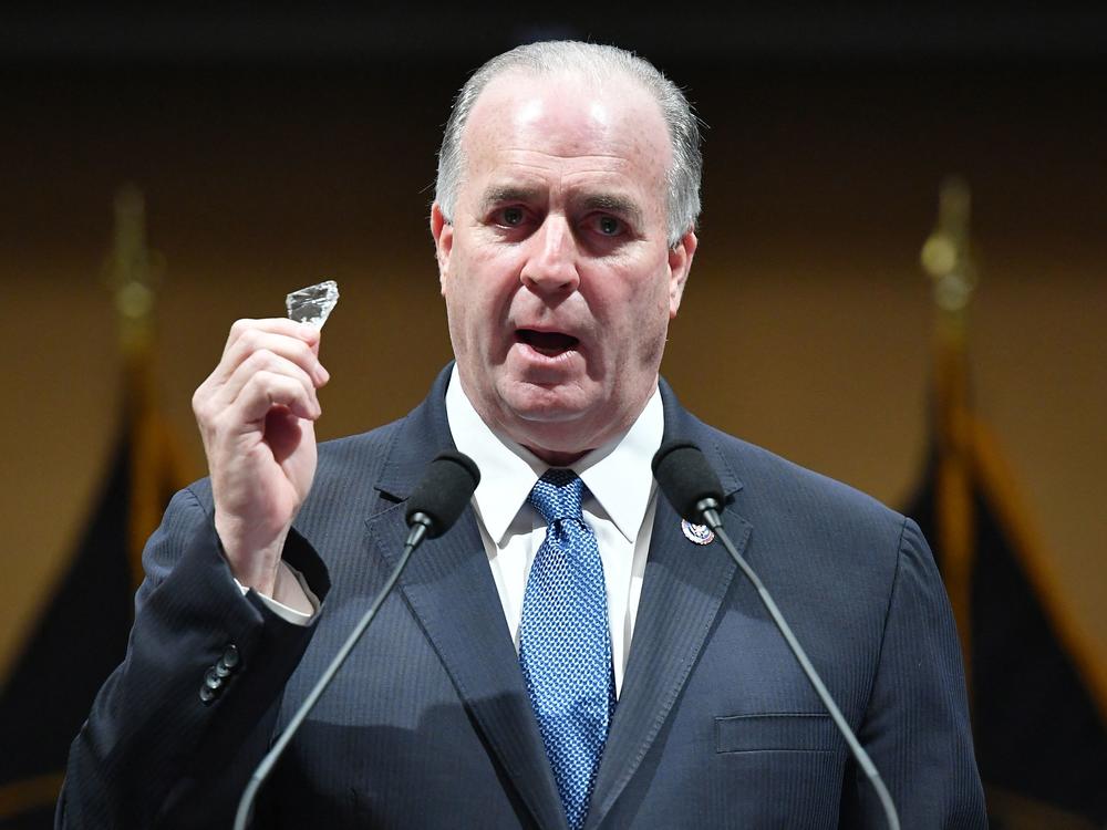 Rep. Dan Kildee, D-Mich., holds a piece of glass that he carries with him as members share their recollections on Jan. 6, 2022 — the first anniversary of the U.S. Capitol insurrection. Kildee found the piece of glass following the 2021 attack on the Capitol.