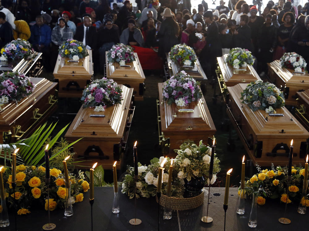 Coffins of 21 teenagers who died in a mysterious tragedy at a nightclub in the early hours of June 26 are lined up during their funeral held in Scenery Park, East London, South Africa, on July 6. The toxic chemical methanol has been identified as a possible cause of the deaths.