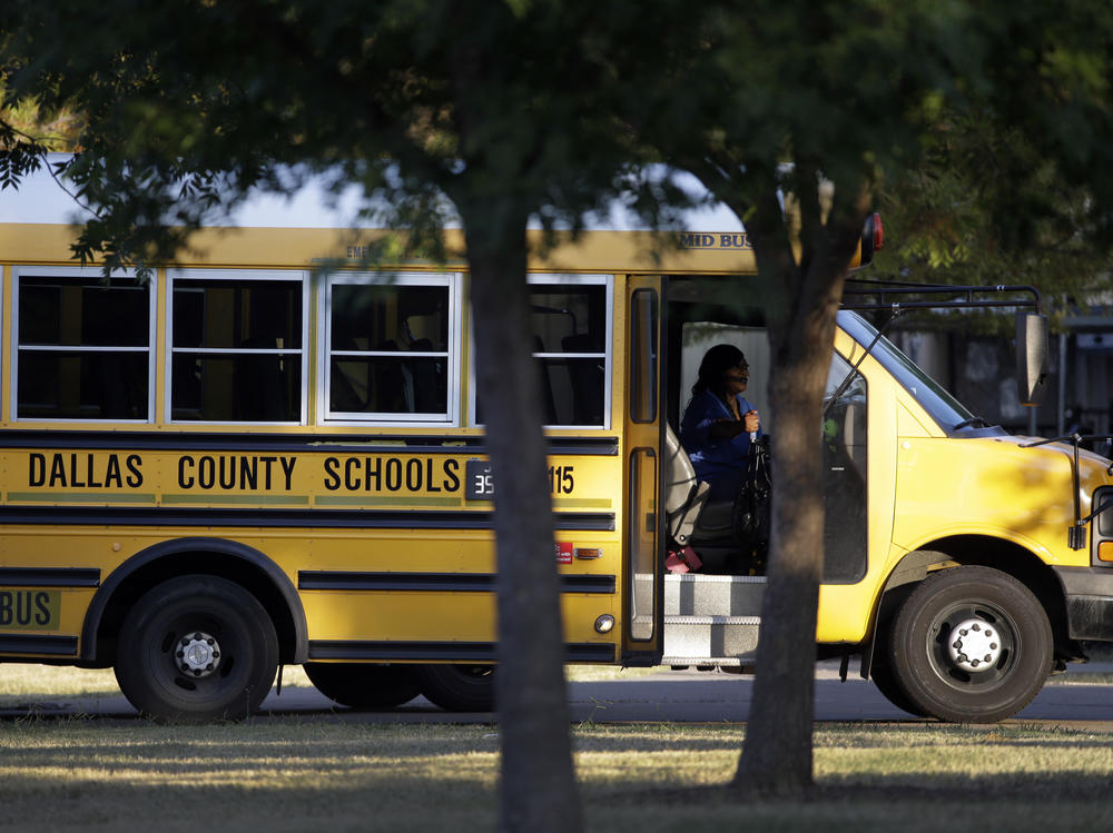 A Dallas Independent School District bus departs L.L. Hotchkiss Elementary school after dropping off students, Thursday, Oct. 2, 2014, in Dallas.