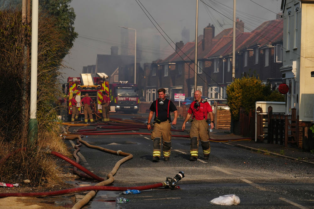 Firefighters in Wennington, a parish near London. The mayor of London said emergency services had battled a dozen major fires on Tuesday.