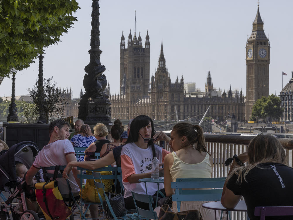 Residents of London enjoy some shade on Tuesday, as the United Kingdom recorded its hottest temperature ever.