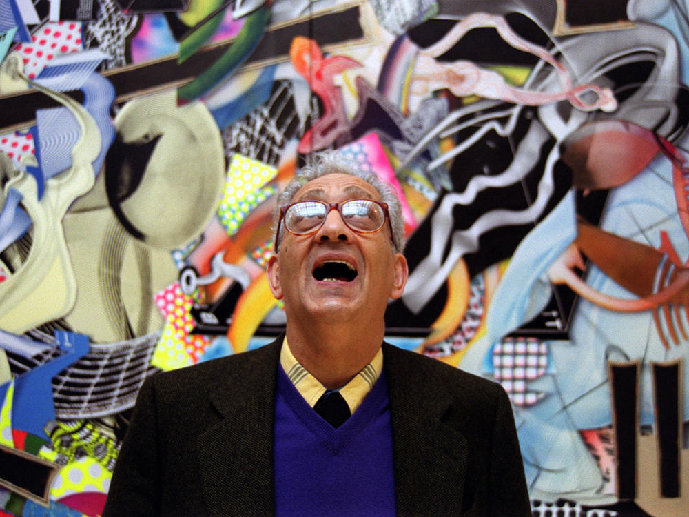 Frank Stella with one of his works at the Royal Academy's Summer Exhibition in London in 2000.