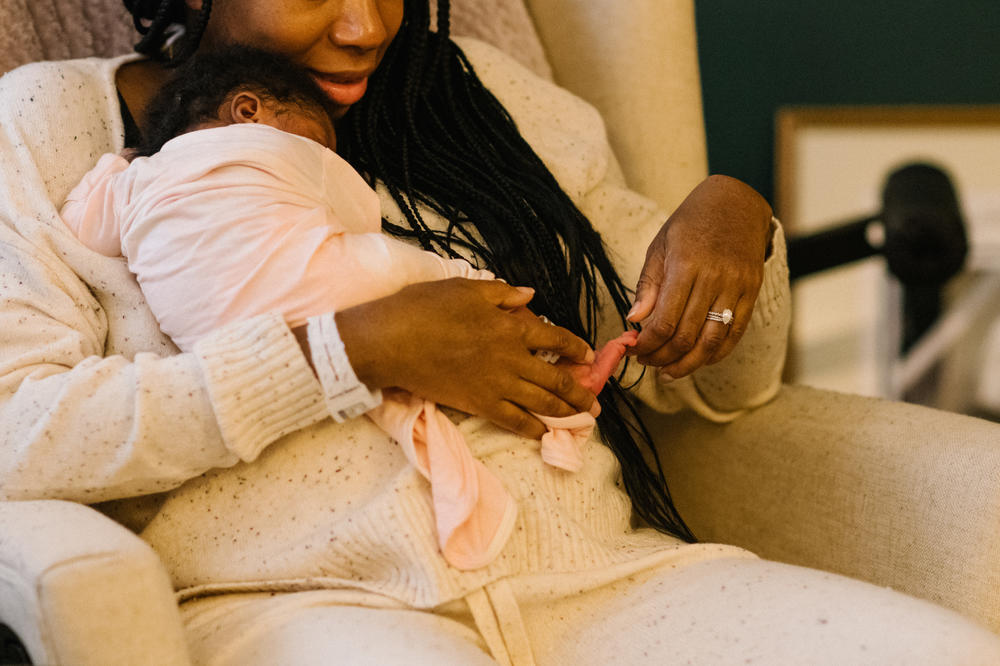 Aimee Jean-Louis rests with her daughter after returning home from the hospital. Speaking to the high rate of deliveries by cesarean section, Kemp acknowledged that there are times where medical intervention is necessary for the health and safety of both babies and their mothers, but that the medical definition of harm reduction should encompass more than the physical experience.