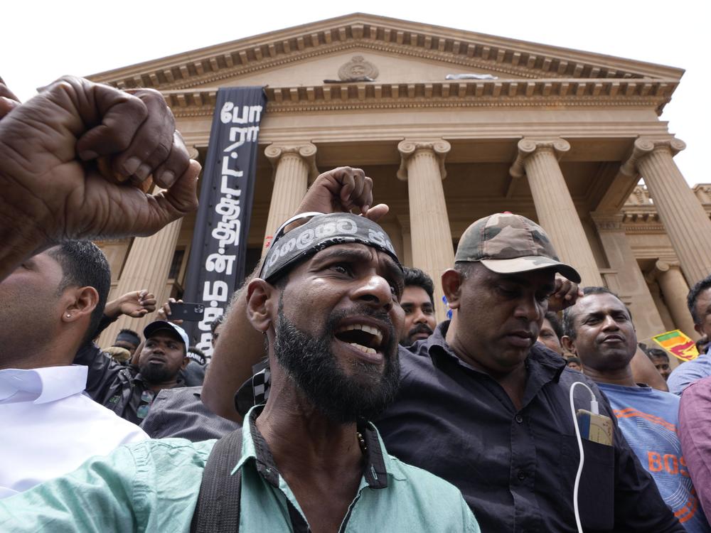 Protesters shout anti-government slogans outside the president's office as the Parliament votes to elect the new president in Colombo, Sri Lanka on Wednesday.