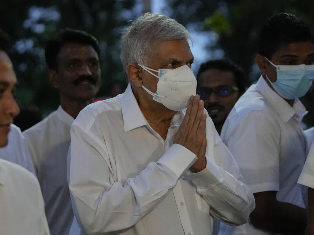 President-elect Ranil Wickremesinghe greats supporters upon his arrival at a buddhist temple in Colombo, Sri Lanka on Wednesday.