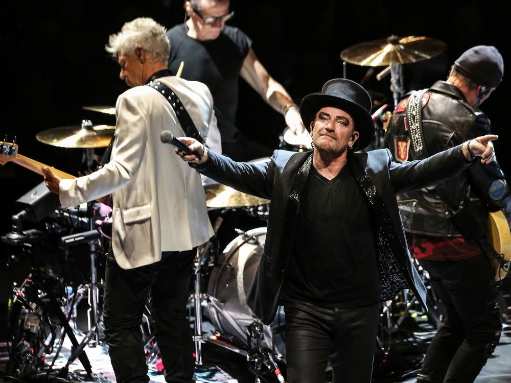 Irish band U2's bass Adam Clayton, drummer Larry Mullen Junior, singer Bono and guitarist The Edge perform in Paris in 2011.