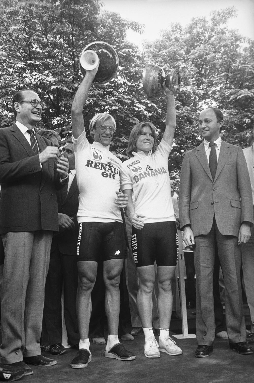 Laurent Fignon, left, of France, and Marianne Martin of Boulder, Colo., hold up their trophies in Paris after winning the men's and women's Tour de France cycling races on July 23, 1984.
