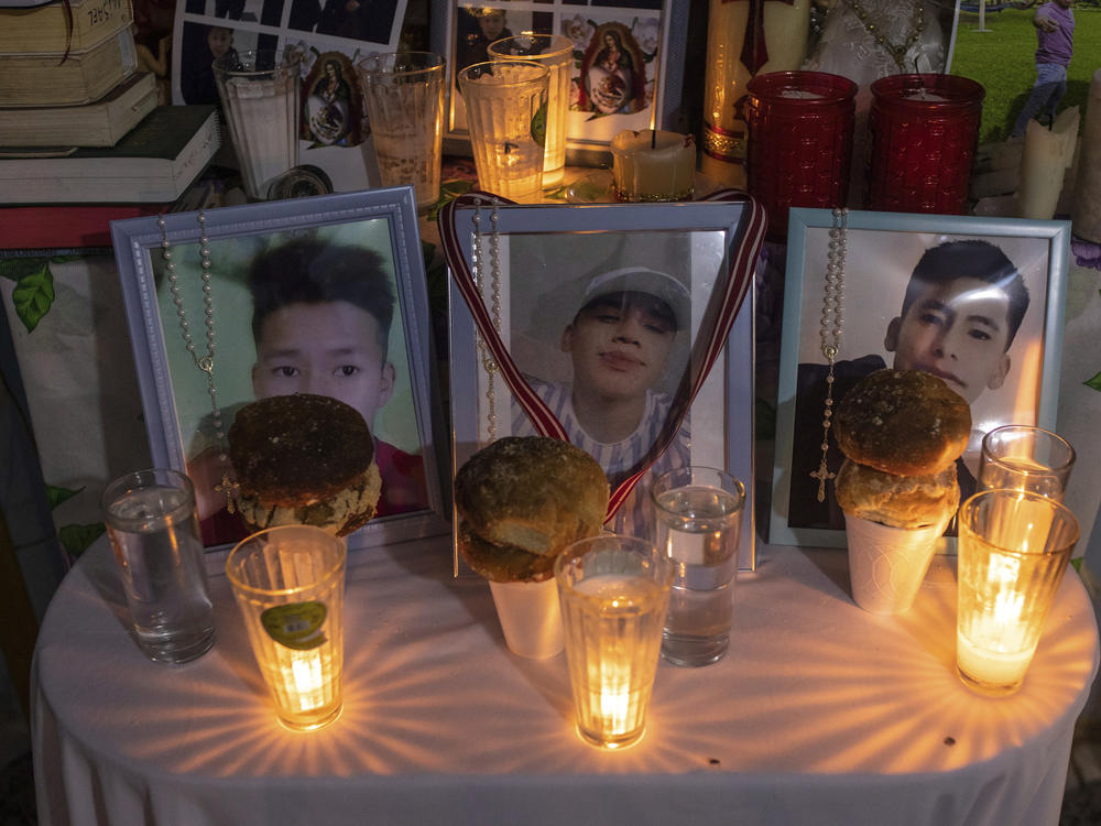 Photos of Jair Valencia, left, Misael Olivares, center, and Yovani Valencia are displayed on an altar at their home in San Marcos Atexquilapan, Mexico, on July 13, 2022. The three were among a group of migrants who died of heat and dehydration in a locked tractor-trailer abandoned by smugglers on the outskirts of San Antonio on June 27.
