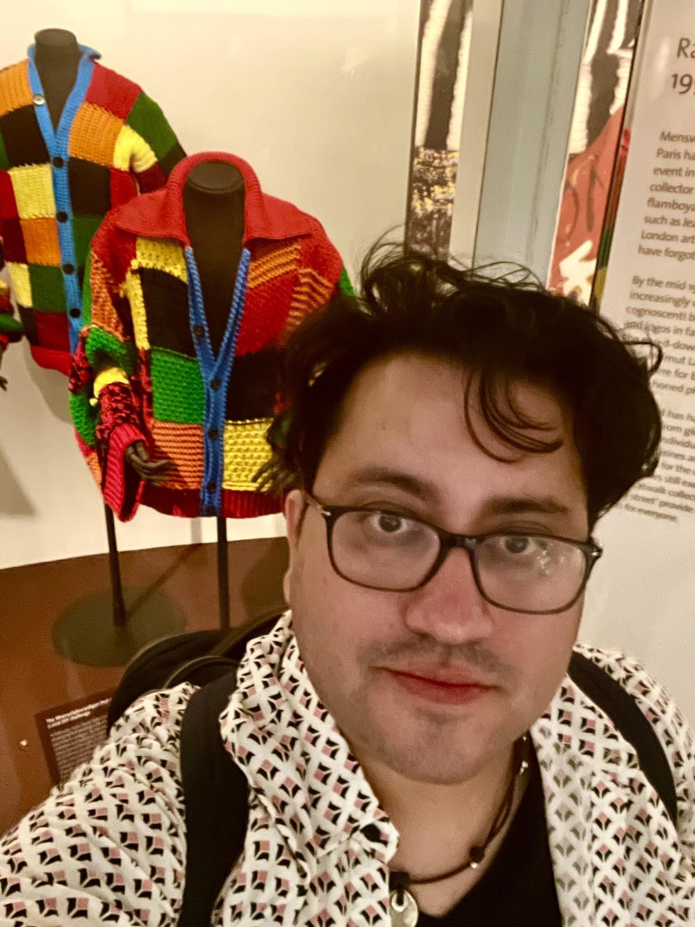 Valencia poses for a selfie at London's Victoria and Albert museum in London, where an exhibit featured the colorful Styles cardigan that inspired a craze during the pandemic.