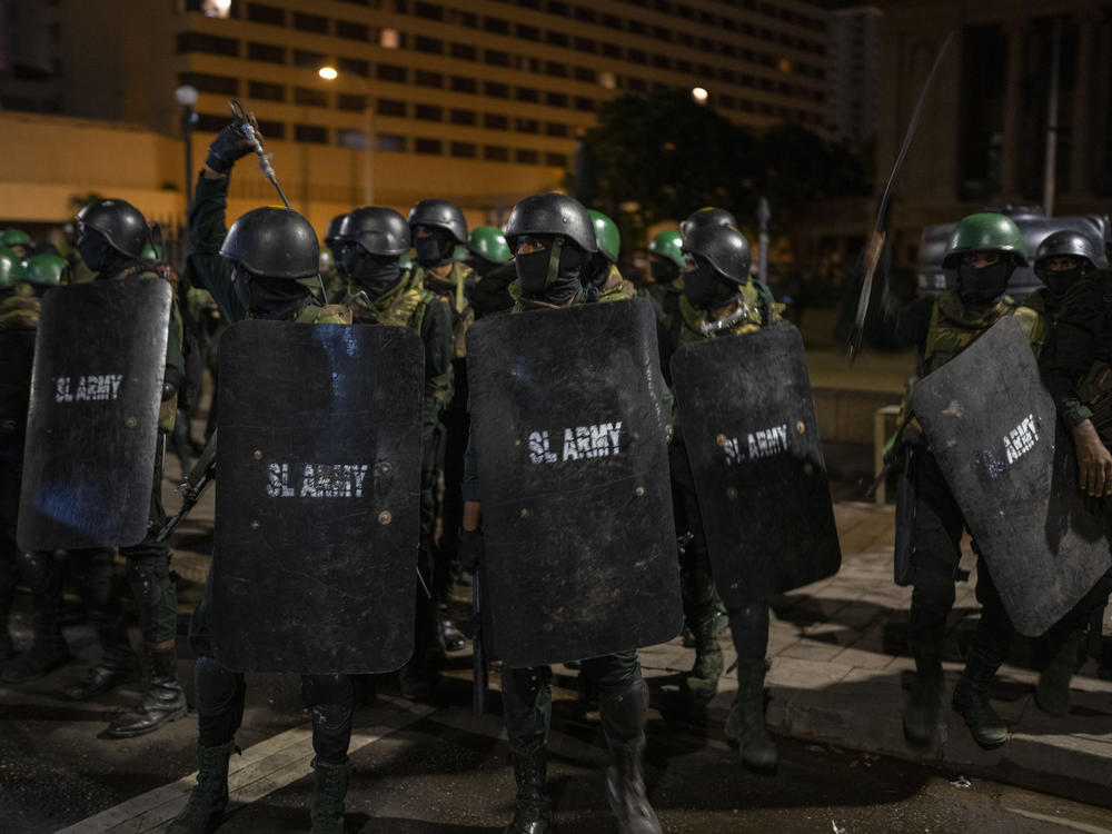 Army soldiers arrive to remove protesters and their tents from the site of a protest camp outside the Presidential Secretariat in Colombo, Sri Lanka, on Friday.