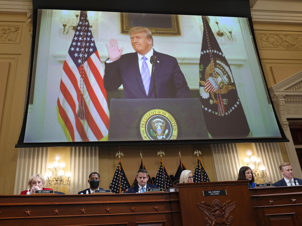 Then-President Donald Trump is seen on the screen above the House select committee investigating the Jan. 6 insurrection on Thursday in outtakes from his Jan. 7, 2021, video in which he refused to say he had lost the election.