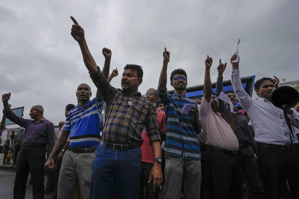 Protesters shout anti-government slogans during a protest against military eviction of protesters from the president's office in Colombo, Sri Lanka, on Friday.