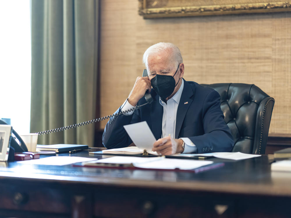 President Biden talks on the phone with his national security team from the Treaty Room in the residence of the White House on Friday.