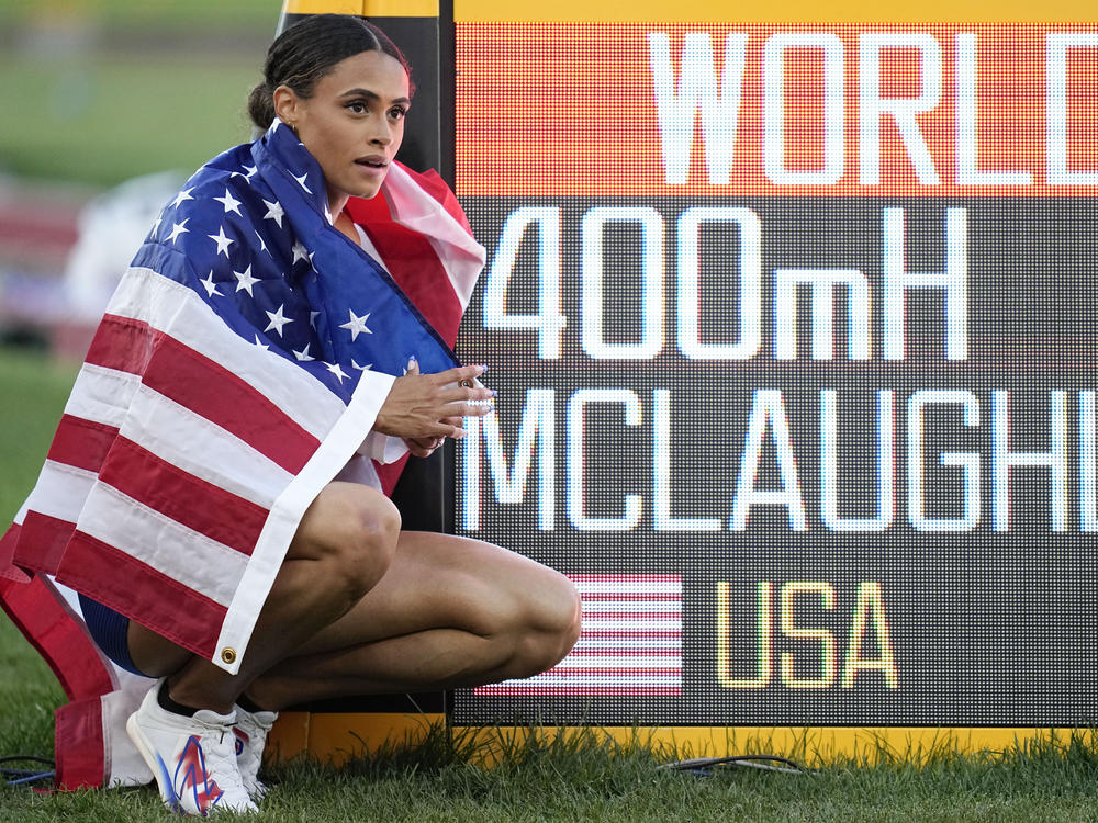 Gold medalist Sydney McLaughlin of the United States poses by a sign after winning the final of the women's 400-meter hurdles at the World Athletics Championships on Friday.