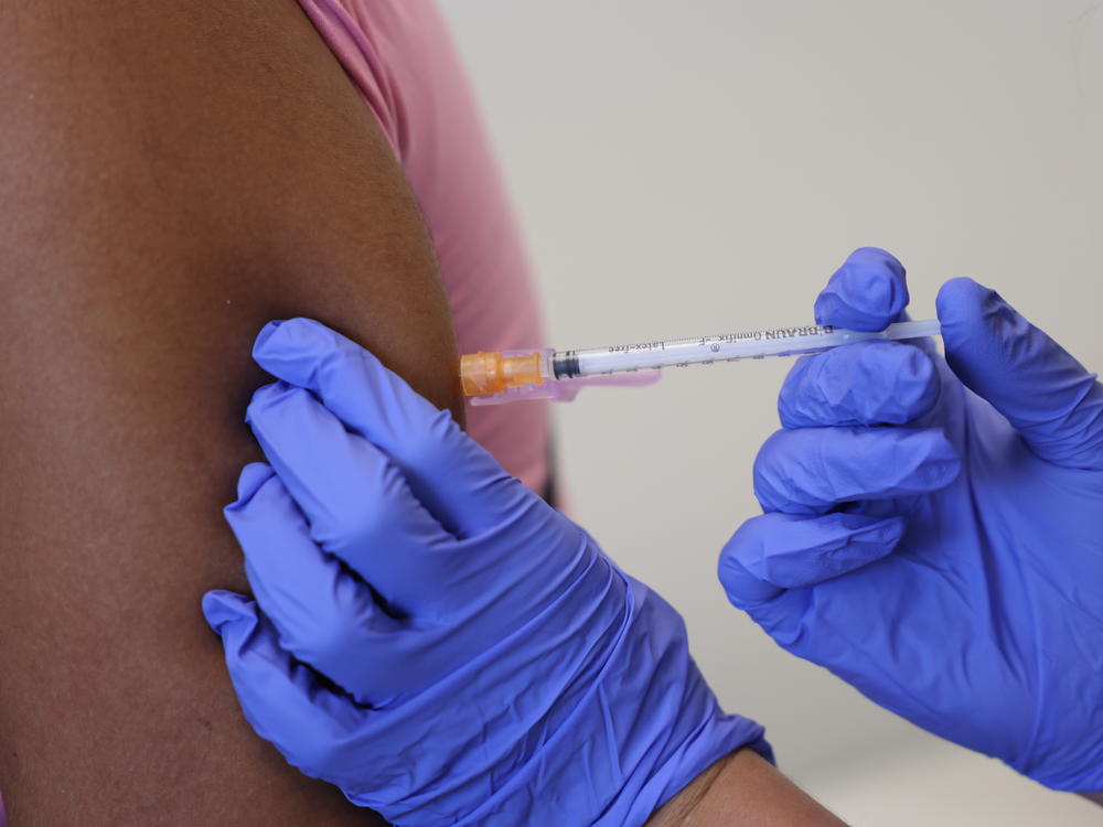 A doctor administers a dose of the monkeypox vaccine on Saturday in London.