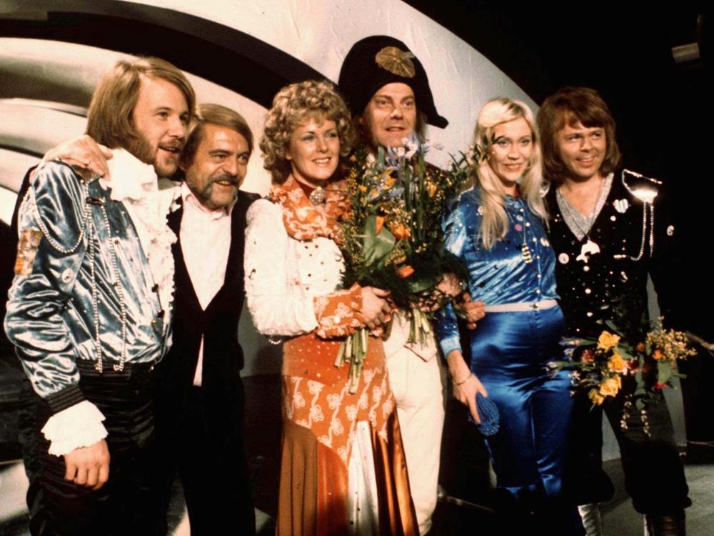 Members of Swedish group ABBA, and their associates, celebrate the victory of their song 
