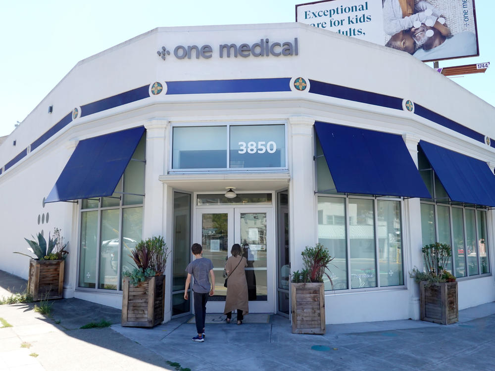 People enter a One Medical office on July 21 in Oakland, Calif. Amazon's plans to buy the company will give it a greater physical presence in health care.