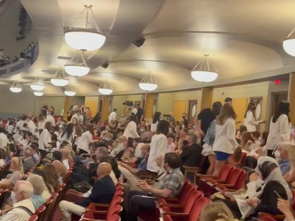 After receiving their white doctor's coats, dozens of incoming medical students at the University of Michigan walked out in protest of a keynote speaker with anti-abortion beliefs.