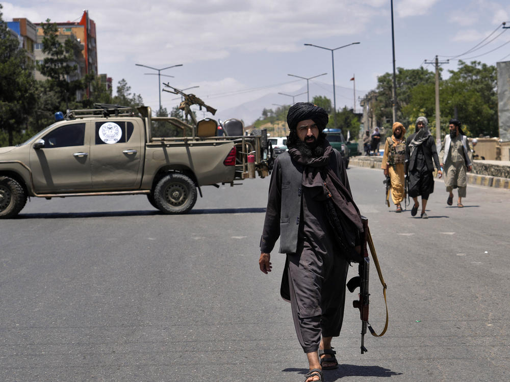 Taliban fighters guard the site of an explosion in Kabul, Afghanistan. Last month, several explosions and gunfire ripped through a Sikh temple in Afghanistan's capital.