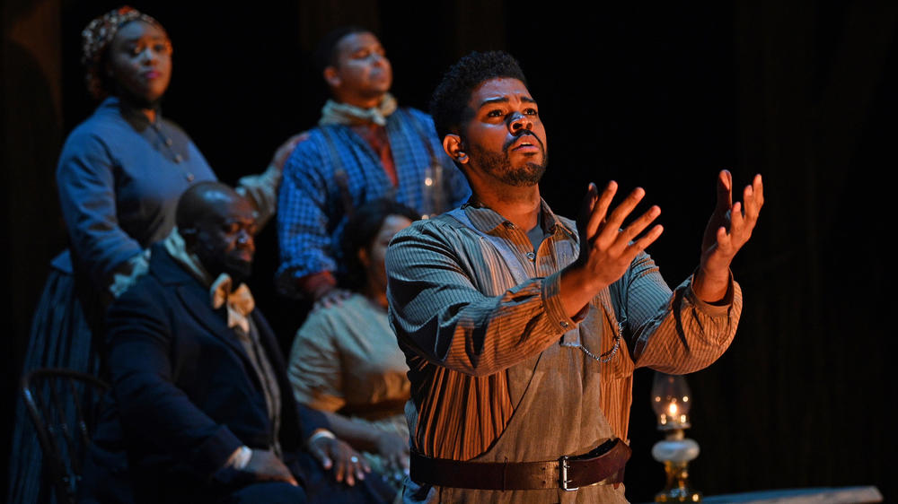 Congregants in one scene in <em>Castor and Patience</em> gather at a Watch Night service to await the hour when the Emancipation Proclamation is to take effect on Jan. 1, 1863. Foreground: Phillip Bullock. Clockwise, from top left: Zoie Reams, Victor Ryan Robertson, Amber Monroe, Earl Hazell.