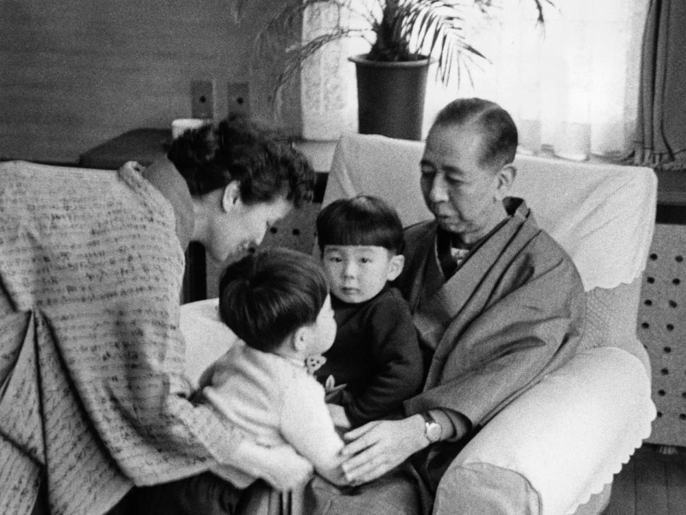 An undated family picture shows Shinzo Abe's grandfather Nobusuke Kishi and his wife Ryoko with Abe and brother Hironobu Abe (on the lap of his grandfather).