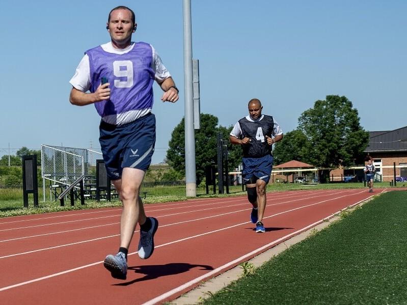 Air Force service members run a timed 1.5 miles during their annual physical fitness test at Scott Air Force Base in Illinois in June. The U.S. Space Force intends to do away with once-a-year assessments in favor of wearable technology.