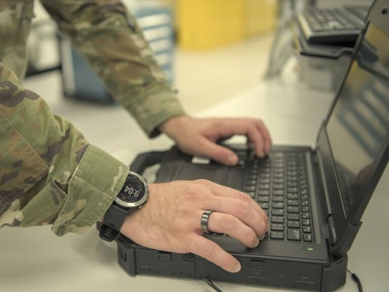 A member of the Air Force 18th Component Maintenance Squadron wears a Garmin watch and an Oura ring as part of a 2021 study. The Space Force is evaluating wearable devices from both manufacturers to monitor troops' health.
