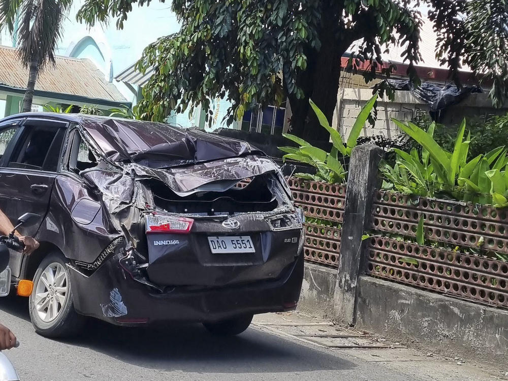 A damaged car is seen along a road after a strong quake hit Bangued, Abra province, in the northern Philippines on Wednesday.