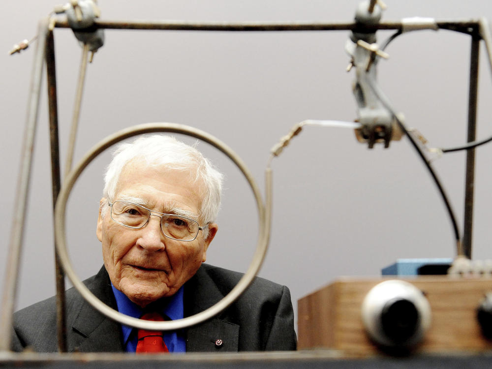 Scientist and inventor James Lovelock poses with one of his early inventions, a homemade gas chromatography device, used for measuring gas and molecules present in the atmosphere, at a science museum in London.