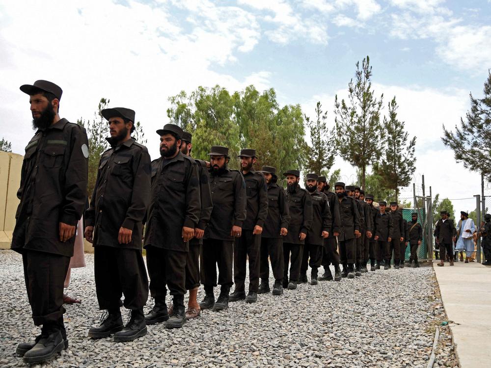 Policemen attend a ceremony to receive new uniforms from the Taliban authorities in Kandahar in July.