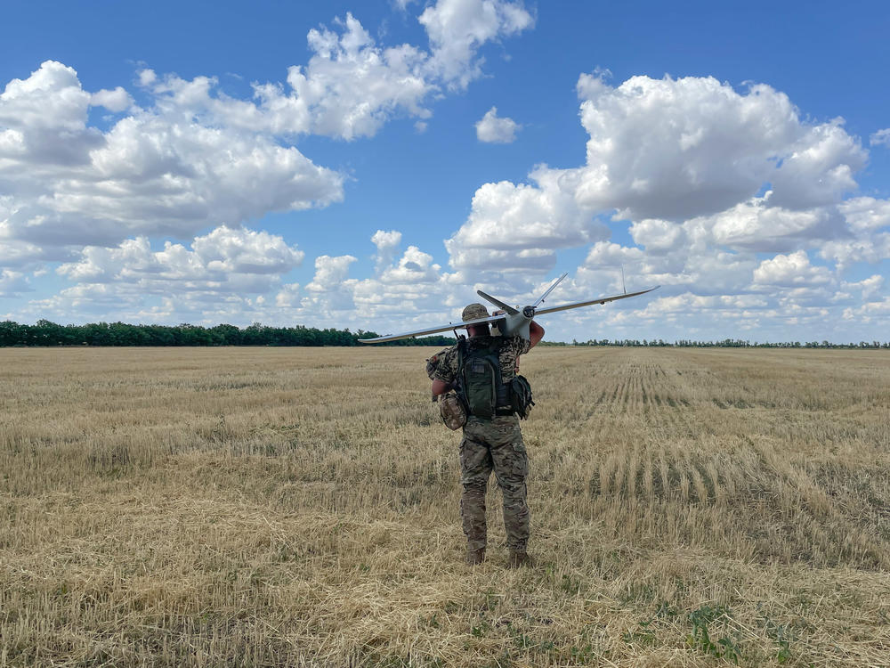 A member of a Ukrainian military surveillance team gets ready to launch a drone from a wheat field in southern Ukraine.