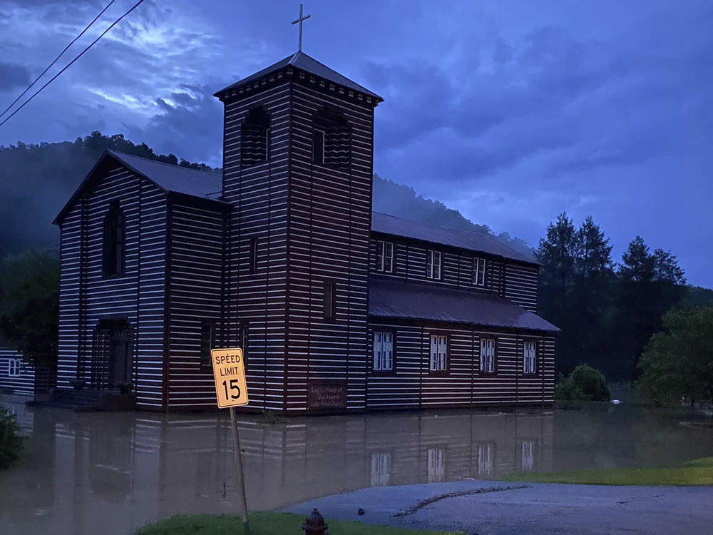 This image provided by Marlene Abner Stokely shows flooding by the Buckhorn Log Cathedral on Thursday in Buckhorn, Ky.