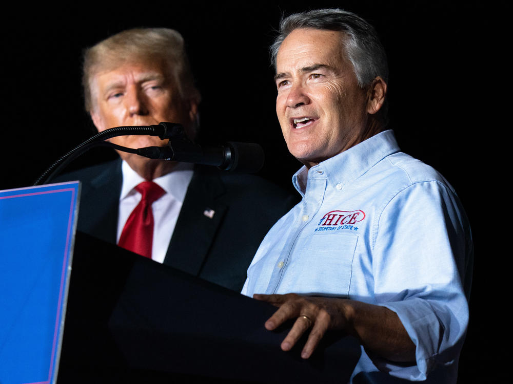 Georgia Rep. Jody Hice speaks during a rally last September as former President Donald Trump looks on. Trump endorsed Hice, who falsely believes fraud tainted the 2020 election, in the Georgia secretary of state race, but Hice was defeated.