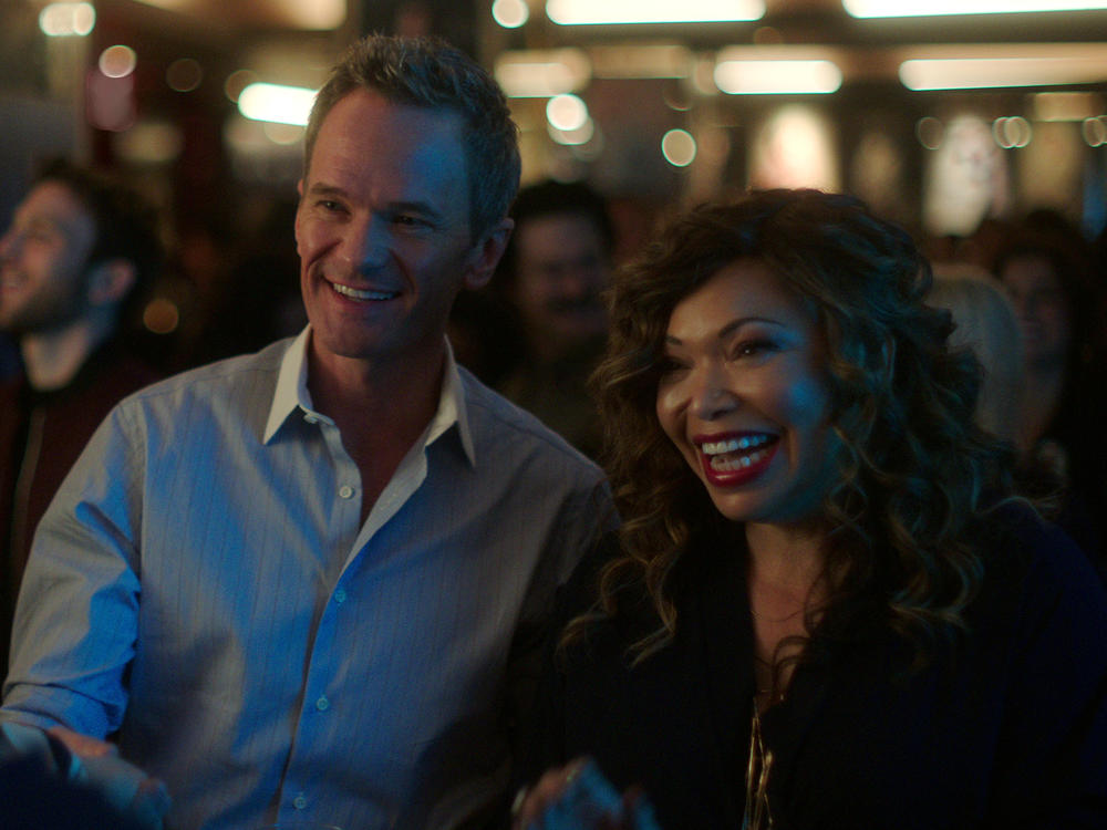 (L to R) Michael (Neil Patrick Harris) and pal Suzanne (Tisha Campbell) schmooze a prospective client.