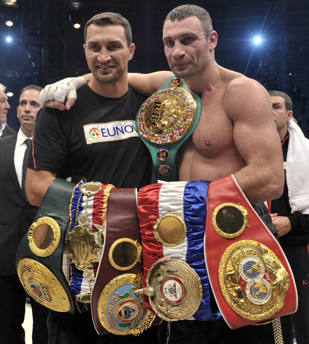 World heavyweight champion Vitali Klitschko (right) celebrates his victory over Poland's Tomasz Adamek in Poland in 2011. Klitschko's brother, Wladimir Klitschko (left), was also a world champion as the two brothers dominated the heavyweight ranks for more than a decade. However, they kept a promise to their mother and never fought each other.
