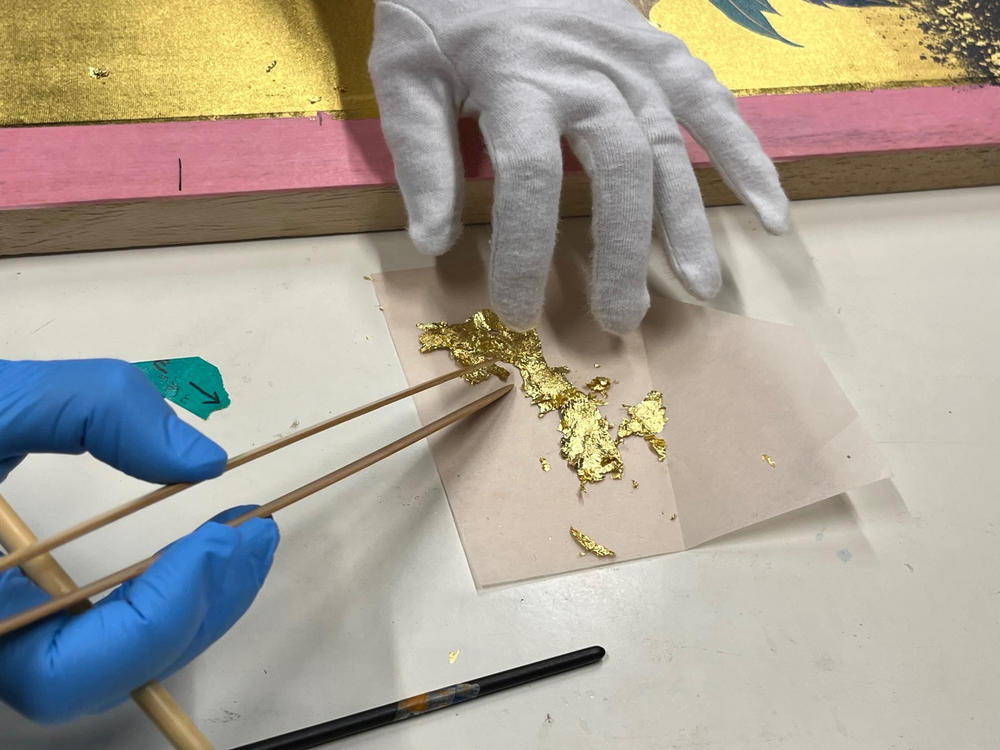 Bamboo tweezers are used to pick up pieces of whisper-thin gold leaf at the Hakuichi factory. It will be applied to a painting.