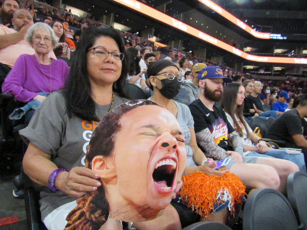 Mercury season ticket holder Patty Talahongva holds an autographed picture of Brittney Griner while watching her WNBA team play in a crucial home game.
