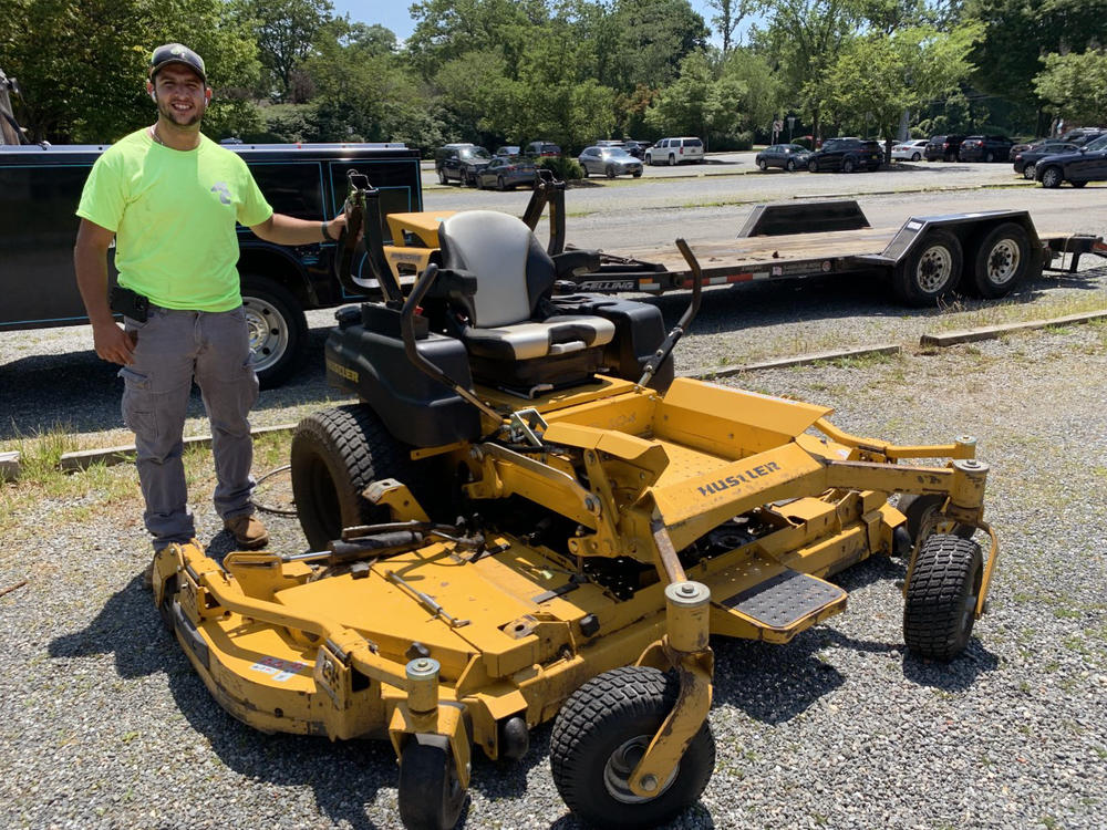 Austin Acocella, co-owner of Acocella Landscaping in Westchester County, N.Y., is holding onto his gas-powered mowers. He says electric ride-ons are too expensive for him to switch right now.
