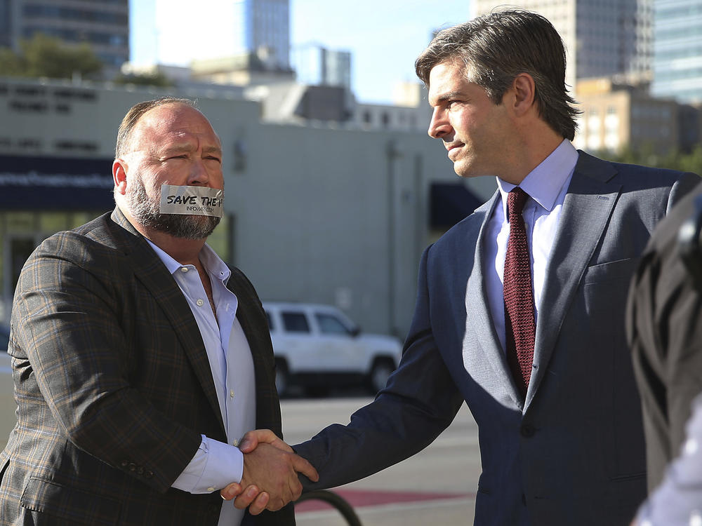 Alex Jones arrives at the Travis County Courthouse in Austin, Texas, on July 26, 2022, with a piece of tape over his mouth that reads 