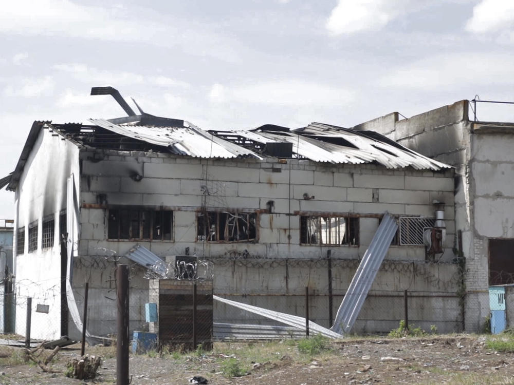 In this photo taken from video, a view of a destroyed barrack at a prison in Olenivka, in an area controlled by Russian-backed separatist forces in eastern Ukraine on Friday.