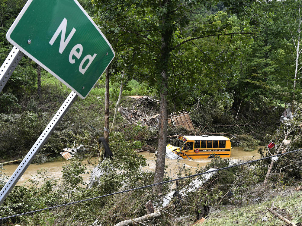 A Perry County school bus lies destroyed after being caught up in the floodwaters of Lost Creek in Ned, Ky., on Friday.