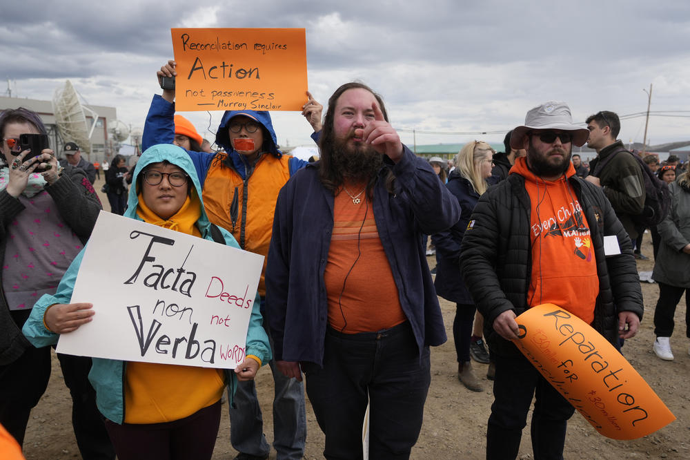 People protest as they wait a meeting with Pope Francis at Nakasuk Elementary School Square in Iqaluit, Canada, on Friday.